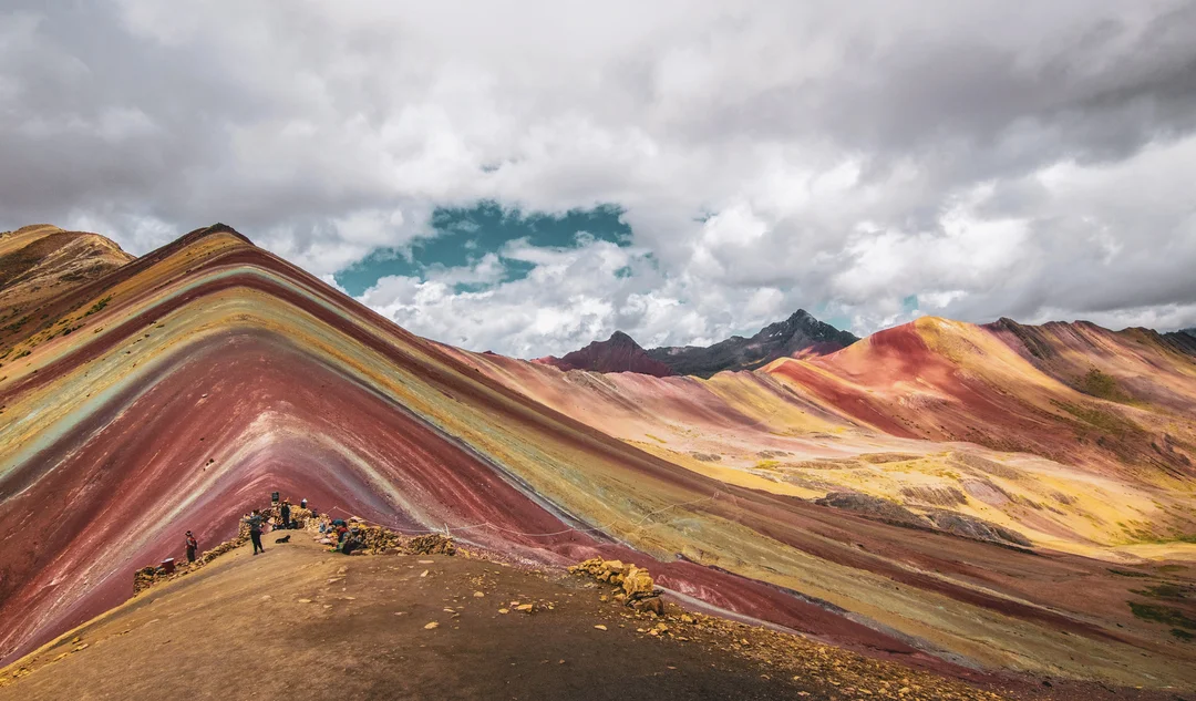 rainbow mountain under grey clouds in Cusco, Peru